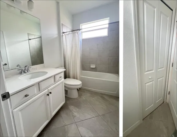 a bathroom with a double vanity sink toilet mirror and shower