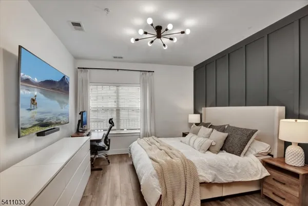 a bed room with a bed window and a television