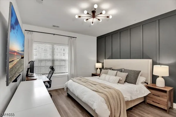 a bedroom with a bed and a chandelier