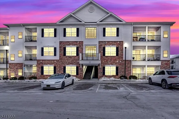 a view of a car parked in front of a brick building