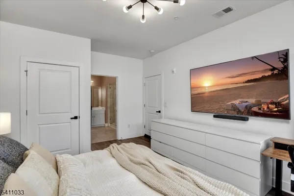 a bedroom with a bed and a chandelier