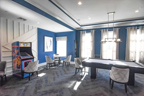 a living room with furniture a fireplace and a chandelier