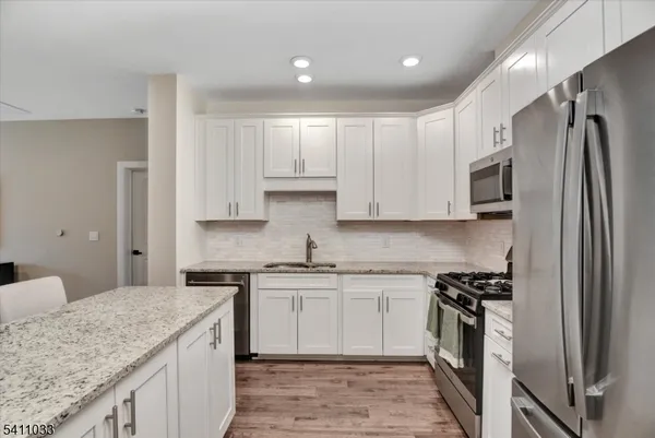a kitchen with a sink stove and refrigerator