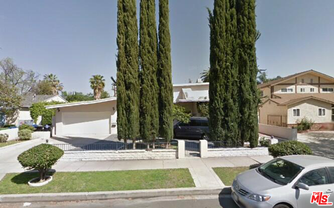 a view of a patio with couches table and chairs and potted plants