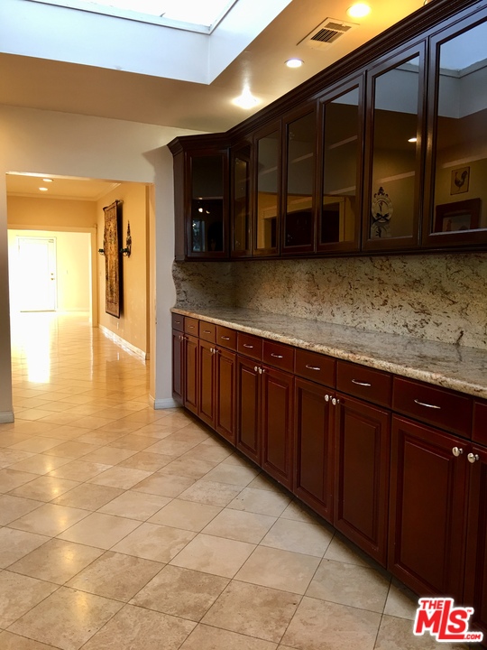 4836 Tyrone Avenue Sherman Oaks, CA 91423 - Photo 3 of 8 a kitchen with stainless steel appliances granite countertop a sink and cabinets