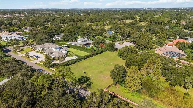 an aerial view of residential houses with outdoor space and swimming pool