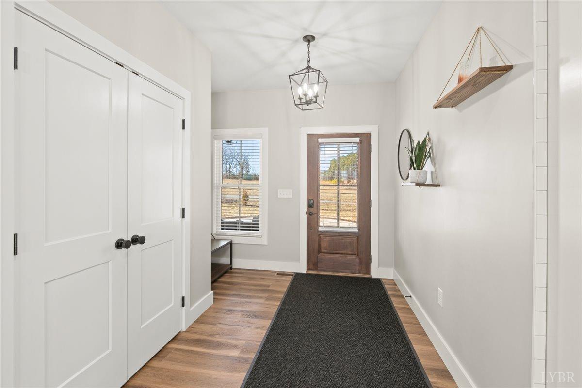 4639 Lowry Road Goode, VA 24556 - Photo 15 of 76 a view of a hallway with windows and chandelier