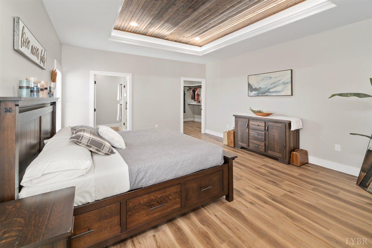4639 Lowry Road Goode, VA 24556 - Photo 25 of 76 a spacious bedroom with a bed and wooden floor