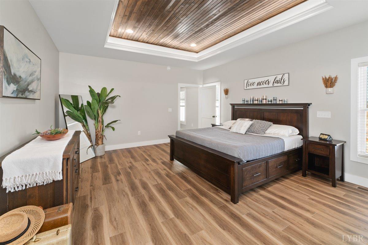 4639 Lowry Road Goode, VA 24556 - Photo 26 of 76 a bedroom with a bed and wooden floor