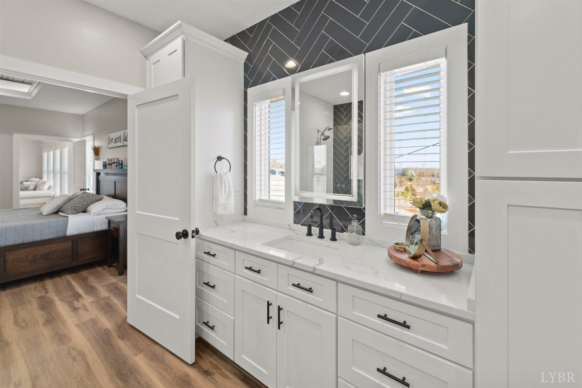 4639 Lowry Road Goode, VA 24556 - Photo 29 of 76 a spacious bathroom with a double vanity sink and a mirror