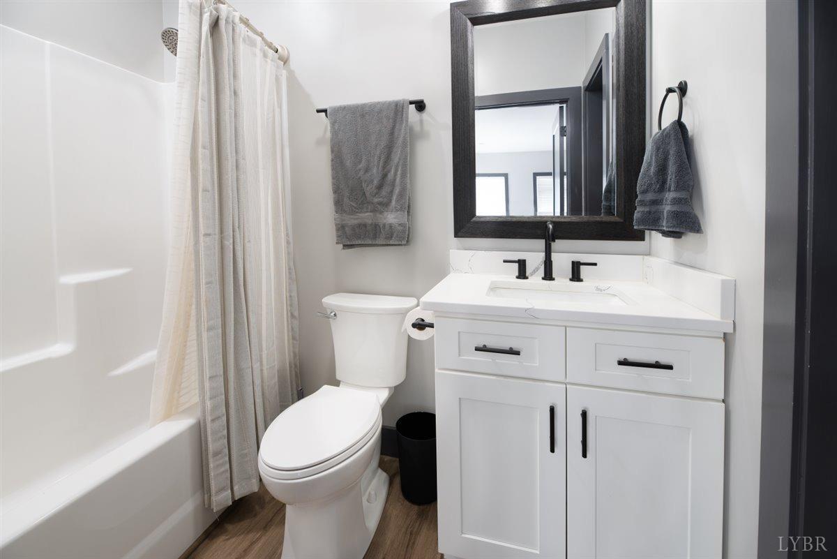 4639 Lowry Road Goode, VA 24556 - Photo 49 of 76 a bathroom with a sink vanity mirror and toilet