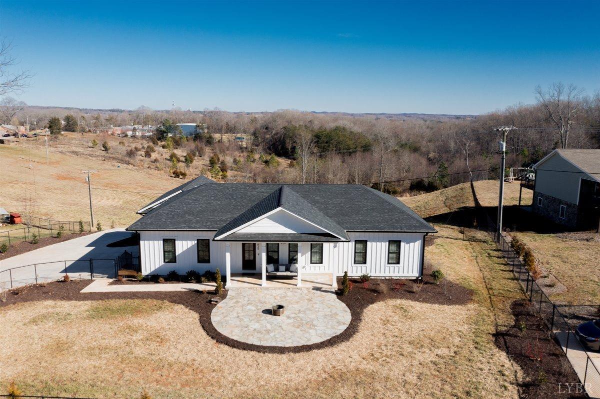 4639 Lowry Road Goode, VA 24556 - Photo 59 of 76 a front view of a house with yard patio and fire pit