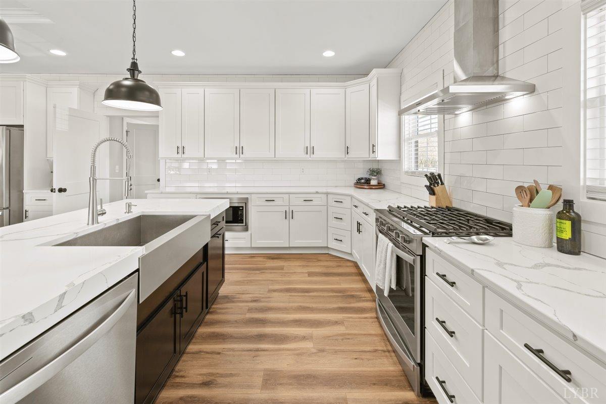 4639 Lowry Road Goode, VA 24556 - Photo 6 of 76 a large kitchen with granite countertop a sink and cabinets