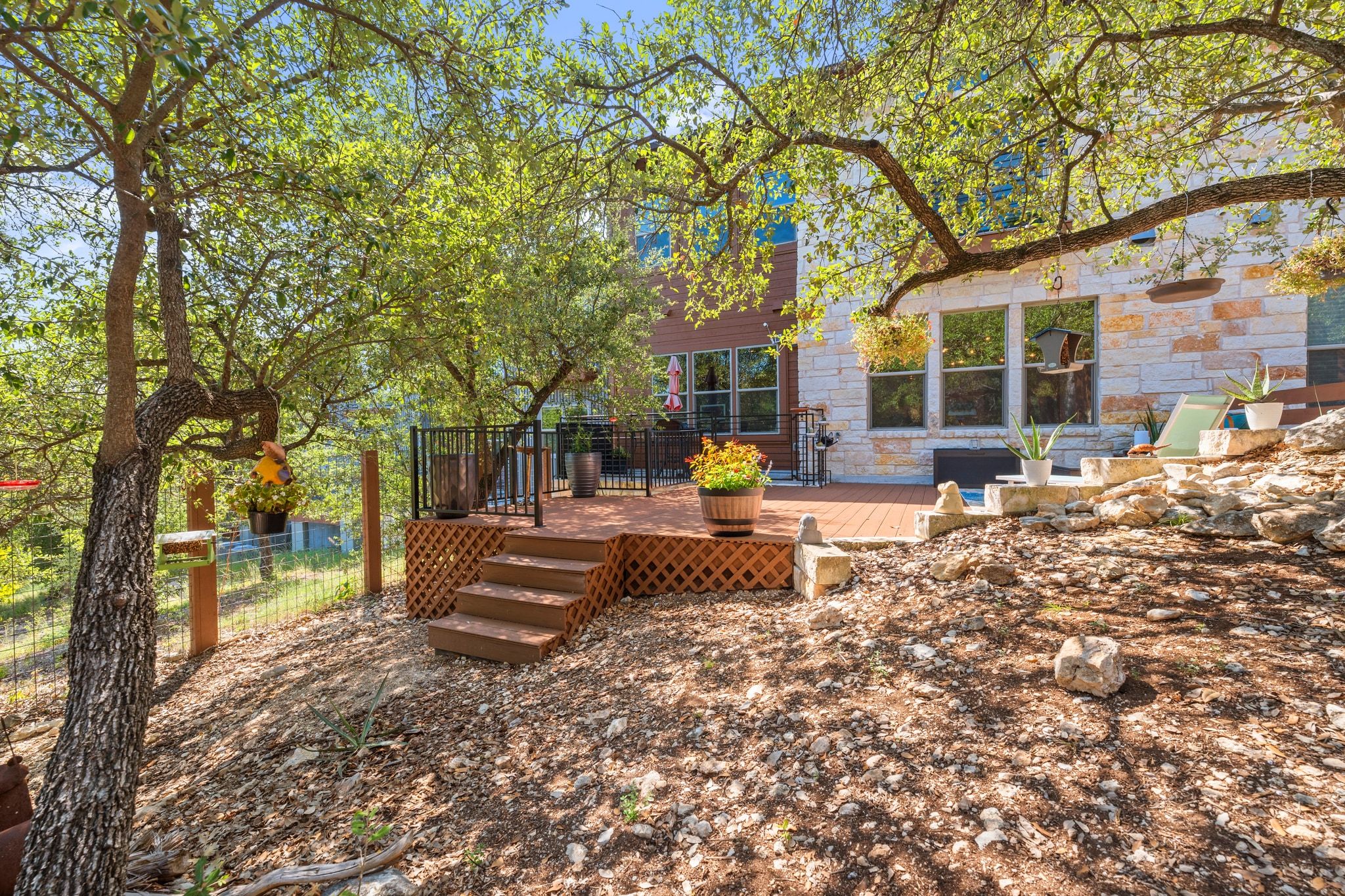 8110 Ranch Road 2222, Unit 92 Austin, TX 78730 - Photo 34 of 40 Multi-level wood-finish deck with black metal railings and lattice skirting