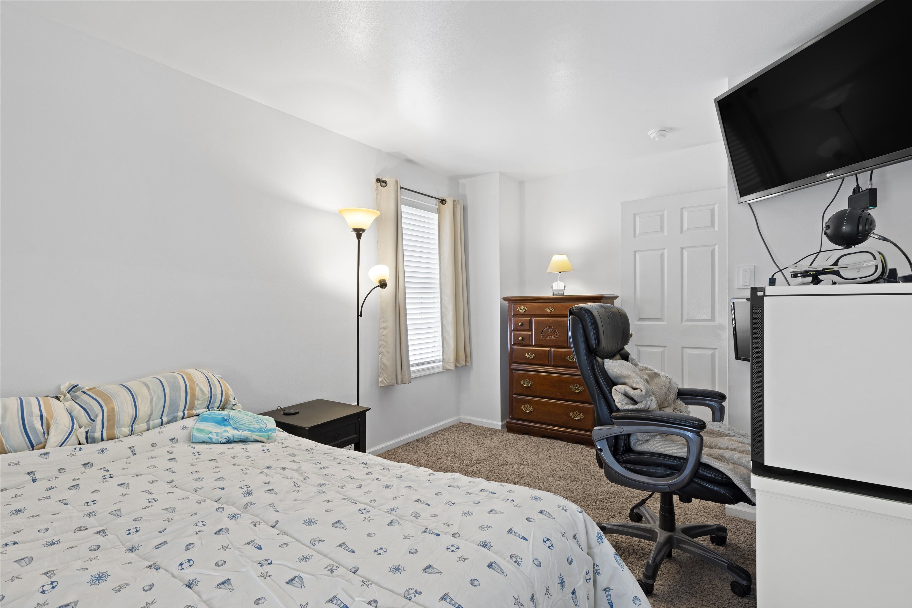 512 West Andrews Avenue, Unit B Wildwood, NJ 08260 - Photo 21 of 25 a bedroom with a bed and a flat screen tv