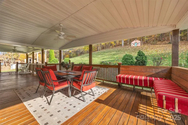 a roof deck with table and chairs and wooden floor