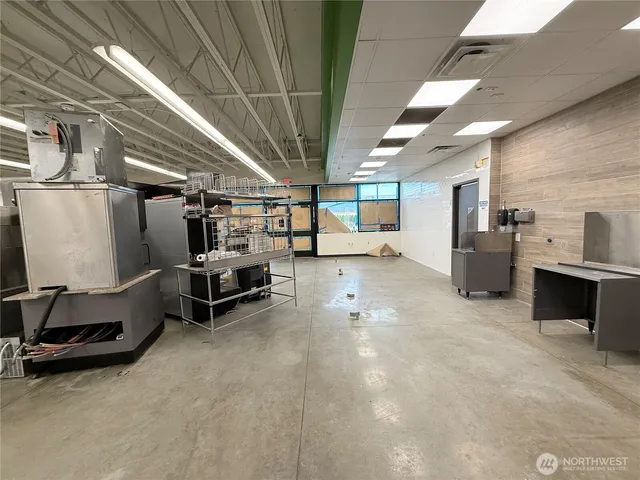 a view of large building with a table and chairs under an umbrella