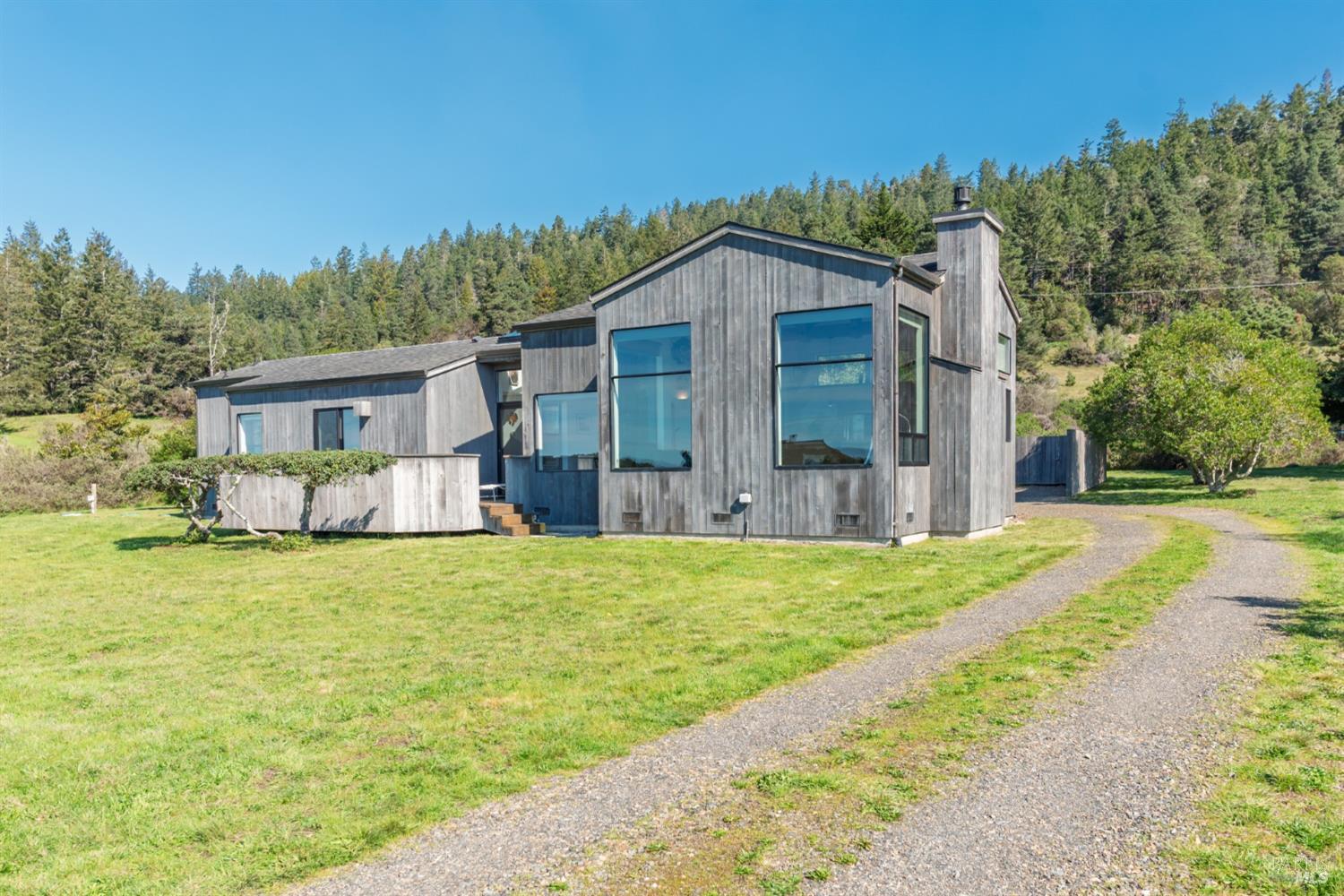 39722 Leeward Road, Unit 28 The Sea Ranch, CA 95497 - Photo 22 of 30 a front view of house with yard and green space