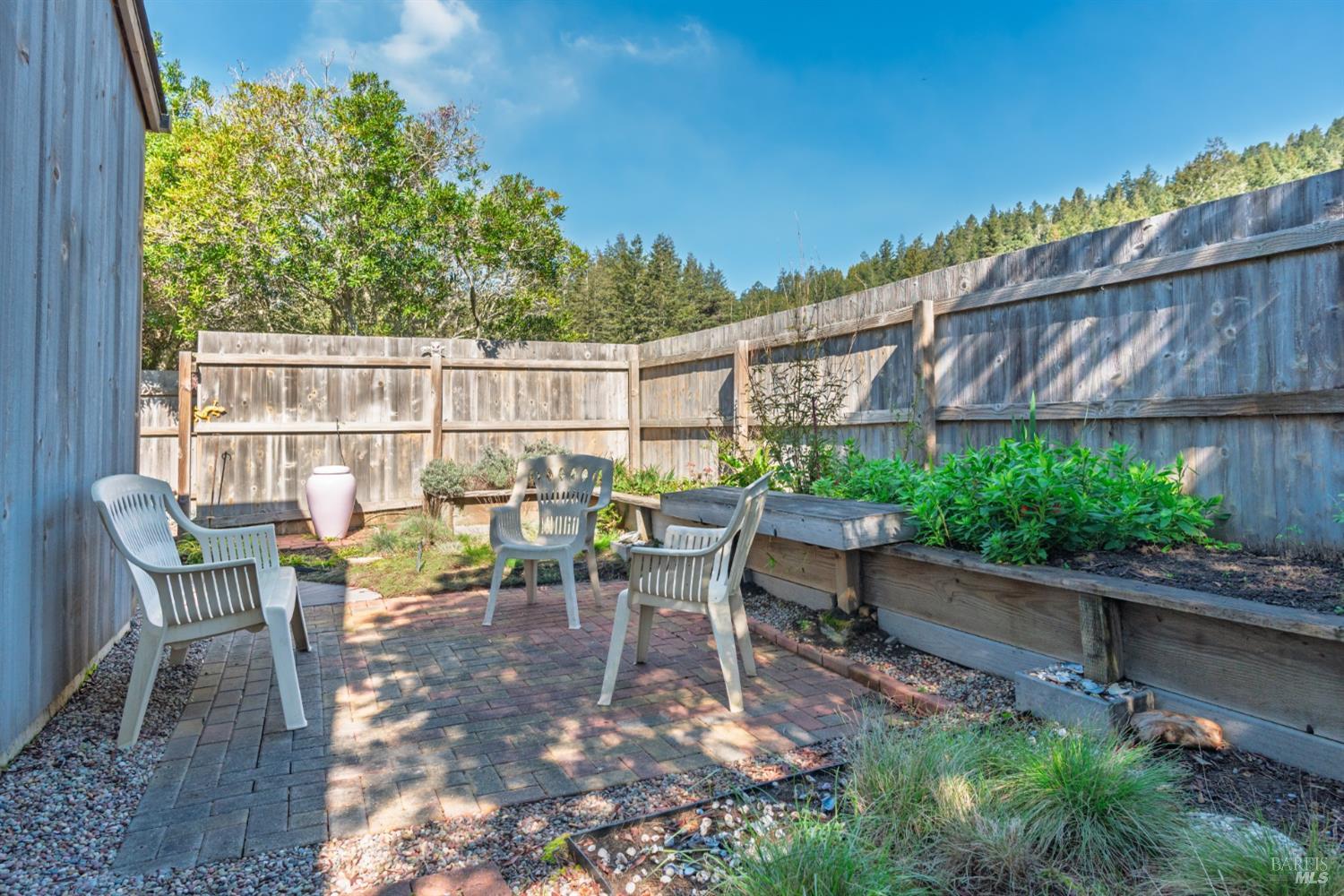 39722 Leeward Road, Unit 28 The Sea Ranch, CA 95497 - Photo 24 of 30 a view of a chairs and table in the back yard of the house