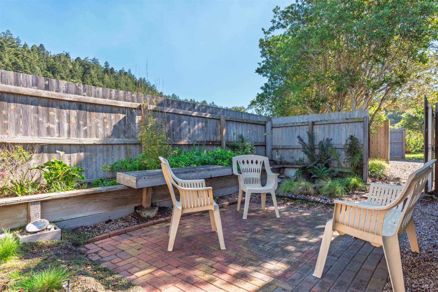 39722 Leeward Road, Unit 28 The Sea Ranch, CA 95497 - Photo 25 of 30 a view of a chair and table in backyard of the house