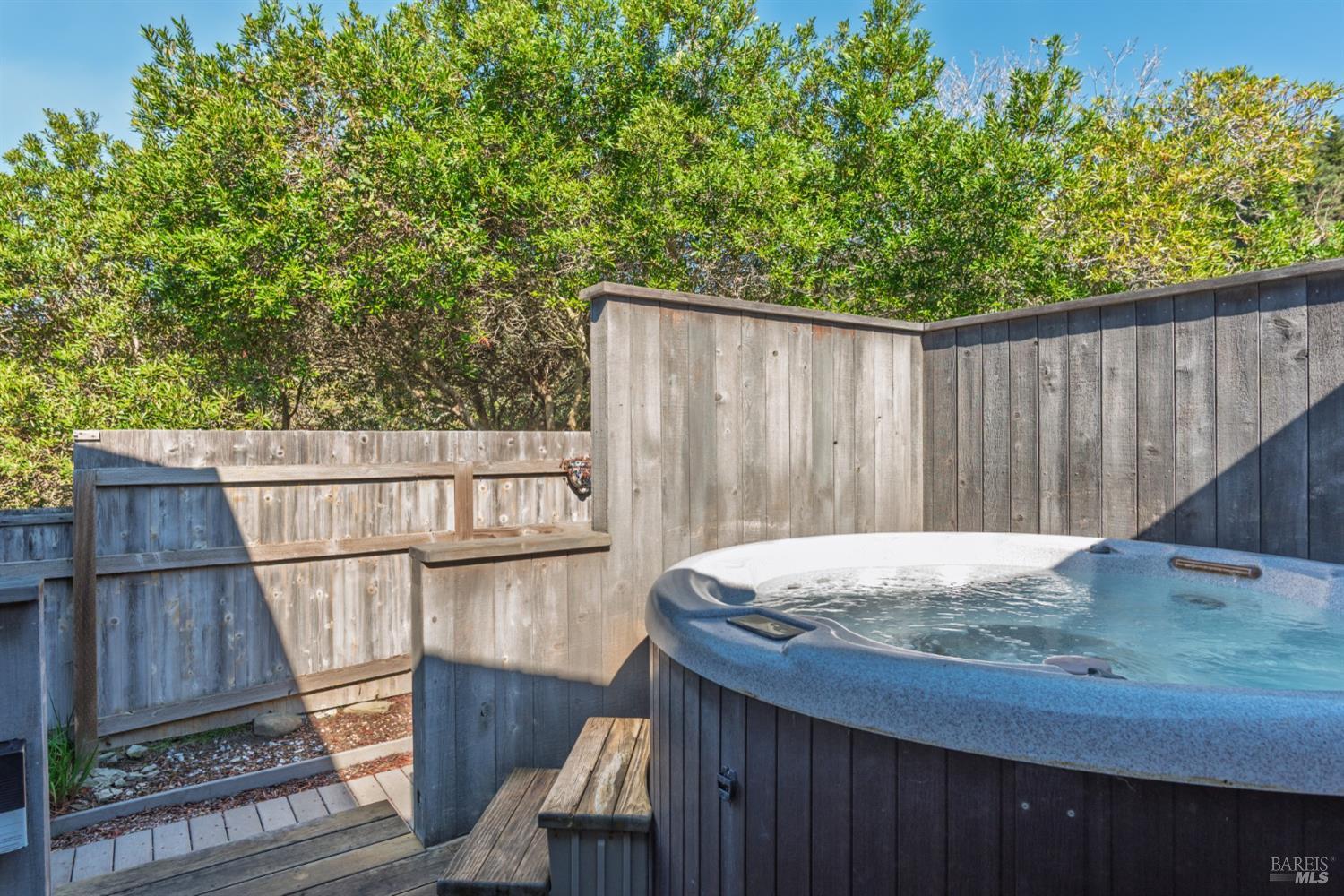 39722 Leeward Road, Unit 28 The Sea Ranch, CA 95497 - Photo 26 of 30 a wooden talbe sitting next to a small yard