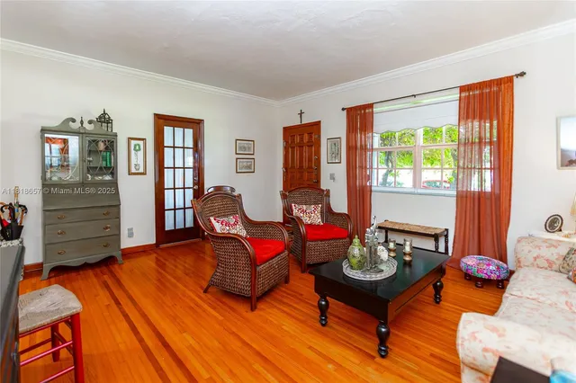 a living room with furniture a rug and a window