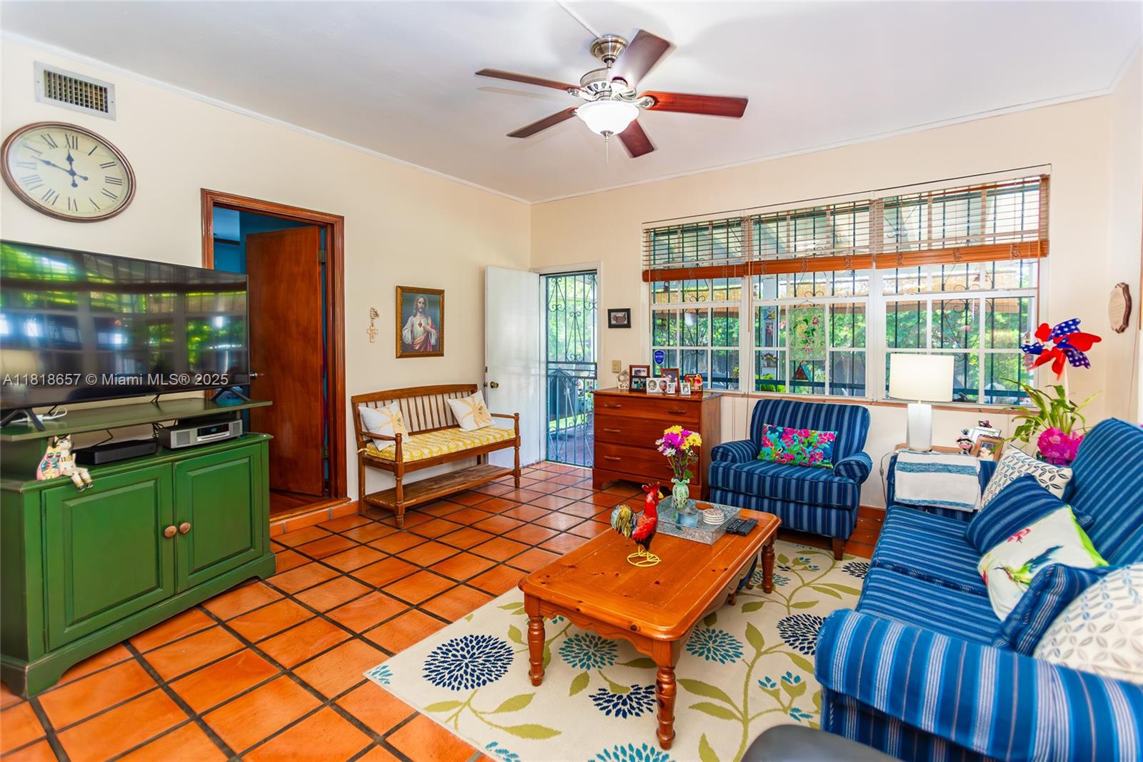7110 Southwest 13th Terrace Miami, FL 33144 - Photo 20 of 48 a living room with furniture a fireplace and a flat screen tv
