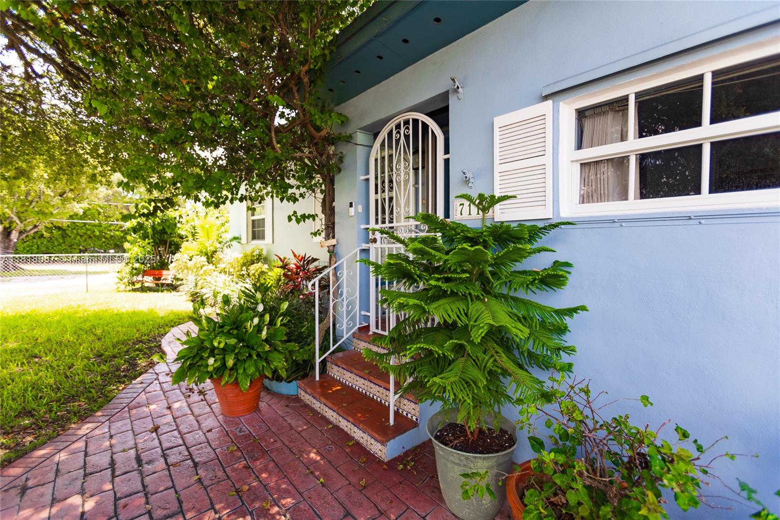 7110 Southwest 13th Terrace Miami, FL 33144 - Photo 2 of 48 a front view of a house with a yard