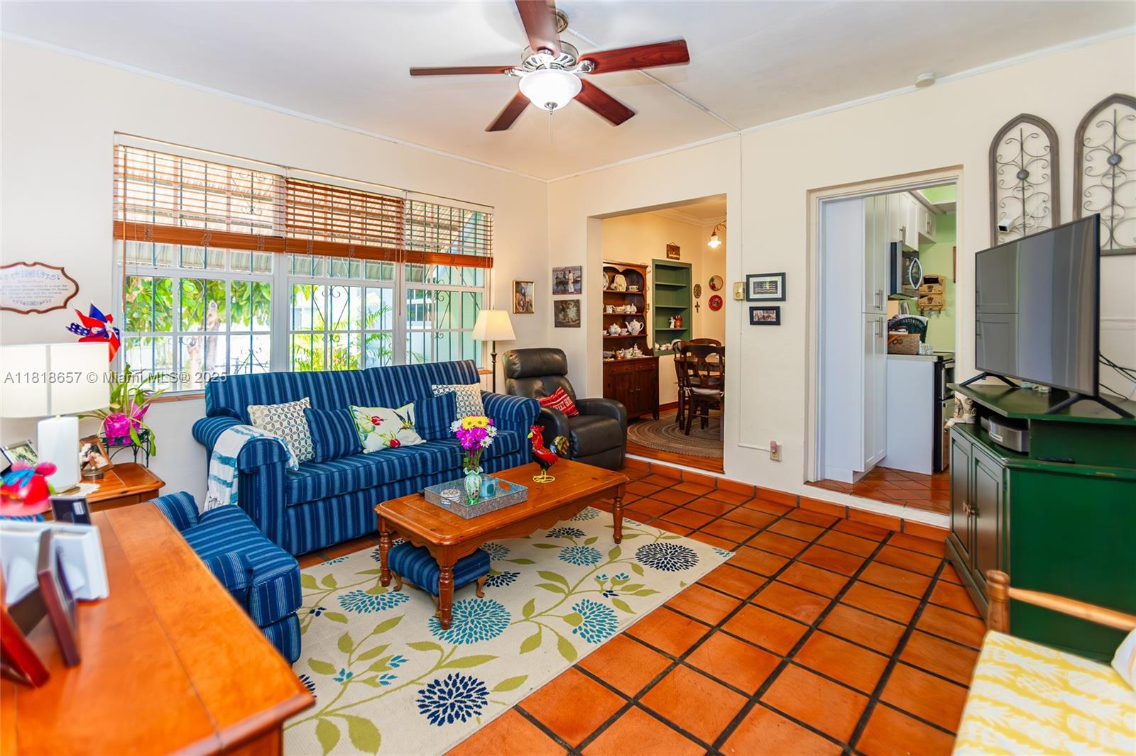 7110 Southwest 13th Terrace Miami, FL 33144 - Photo 21 of 48 a living room with patio furniture and a flat screen tv