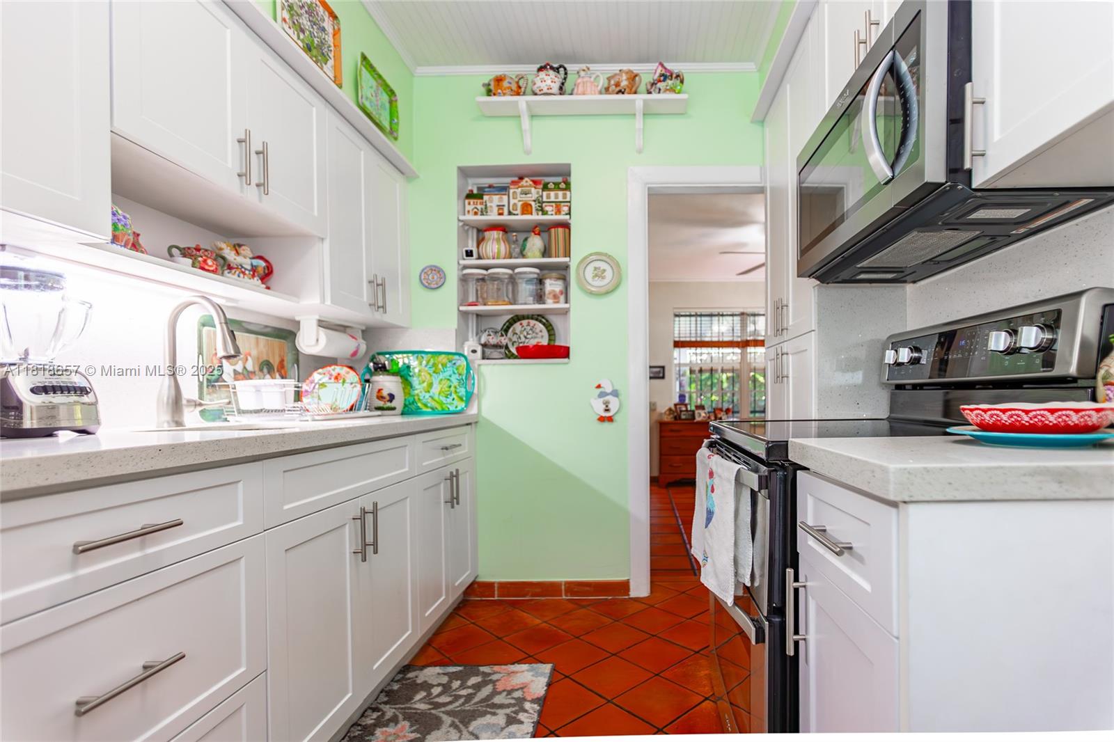 7110 Southwest 13th Terrace Miami, FL 33144 - Photo 24 of 48 a utility room with stainless steel appliances cabinets and a wooden floor