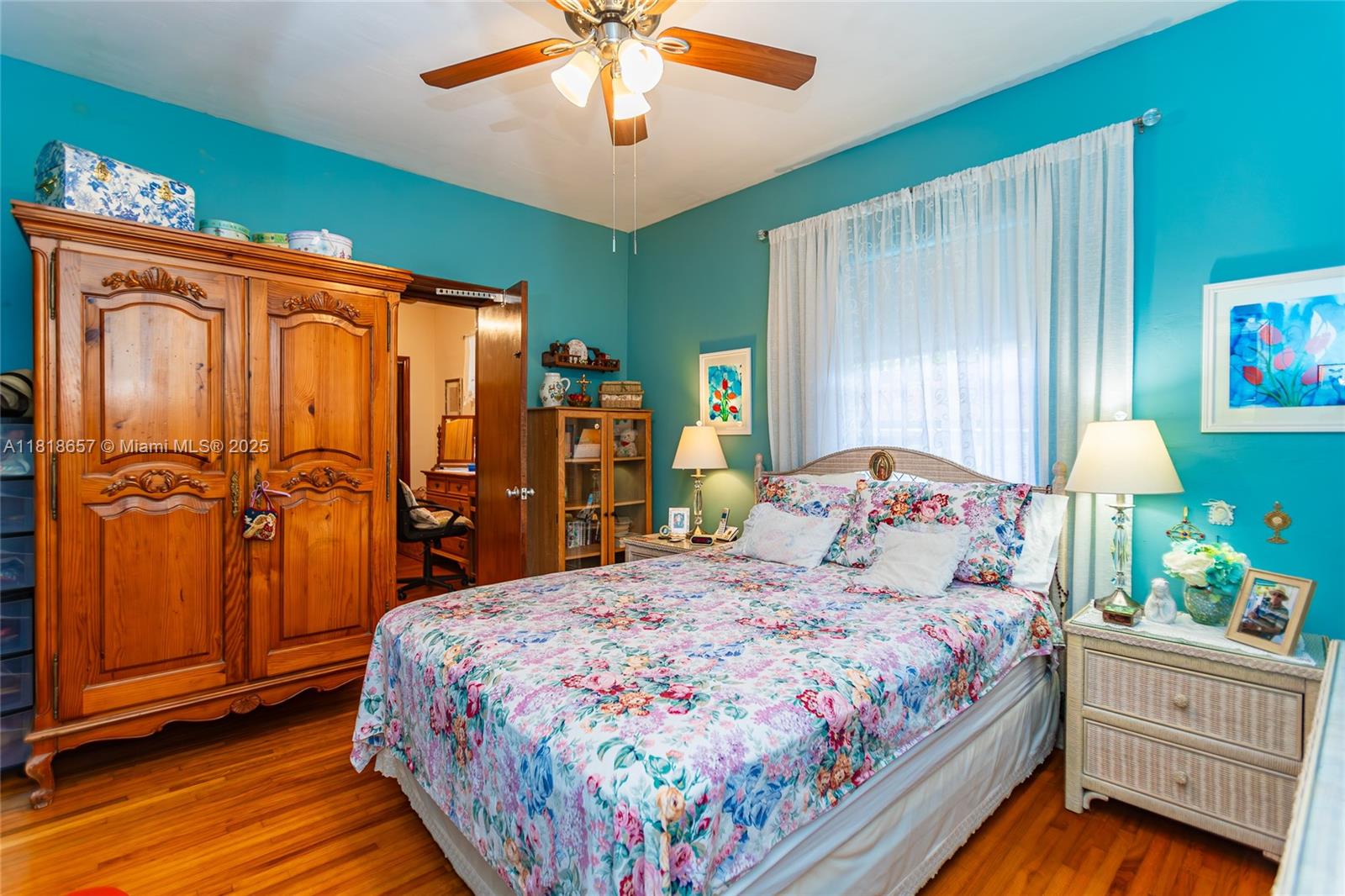 7110 Southwest 13th Terrace Miami, FL 33144 - Photo 29 of 48 a bedroom with a bed and wooden floor