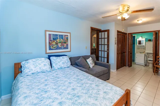 a bedroom with a large bed and a chandelier