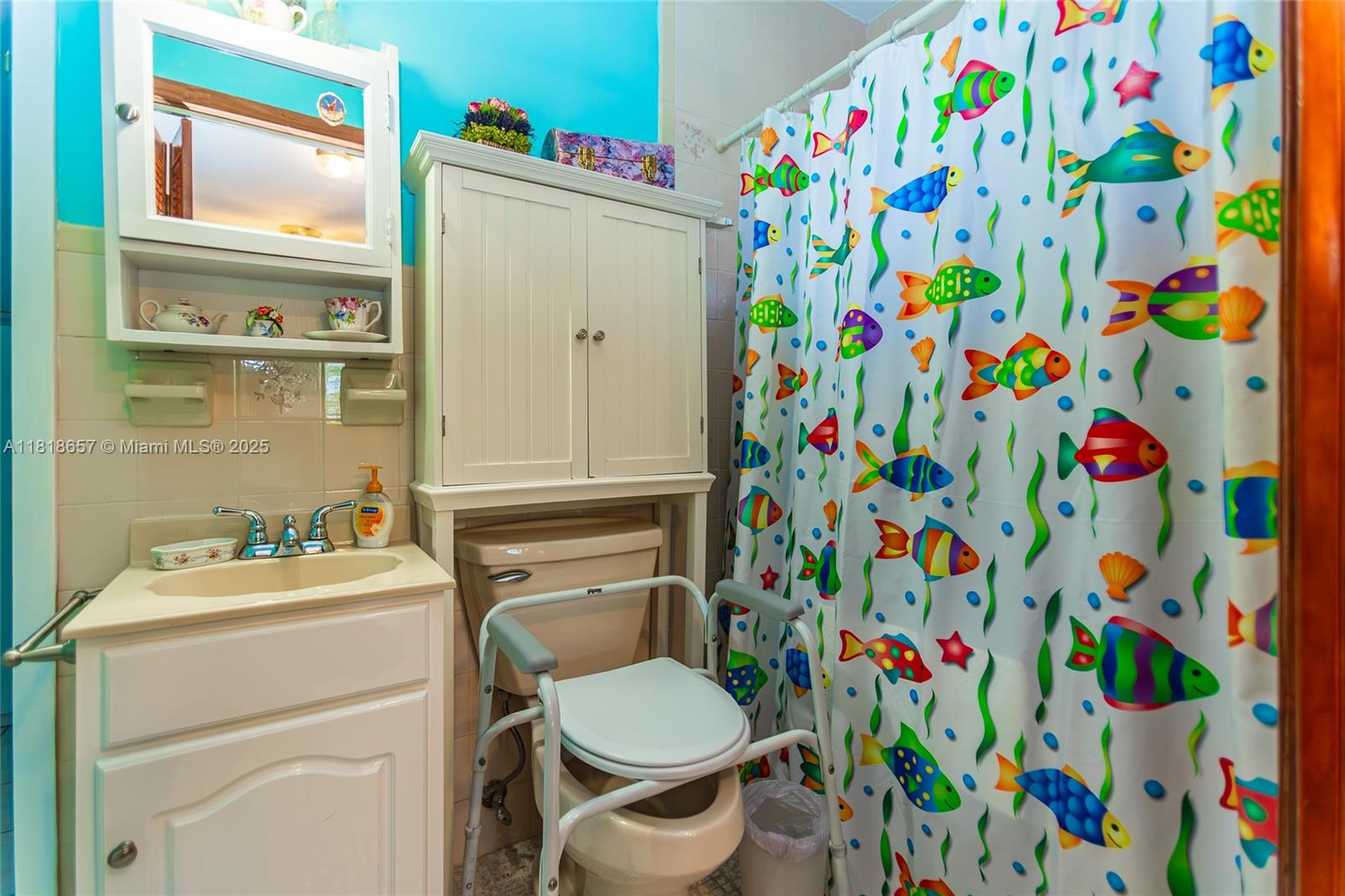 7110 Southwest 13th Terrace Miami, FL 33144 - Photo 39 of 48 a bathroom with a toilet and a sink curtain