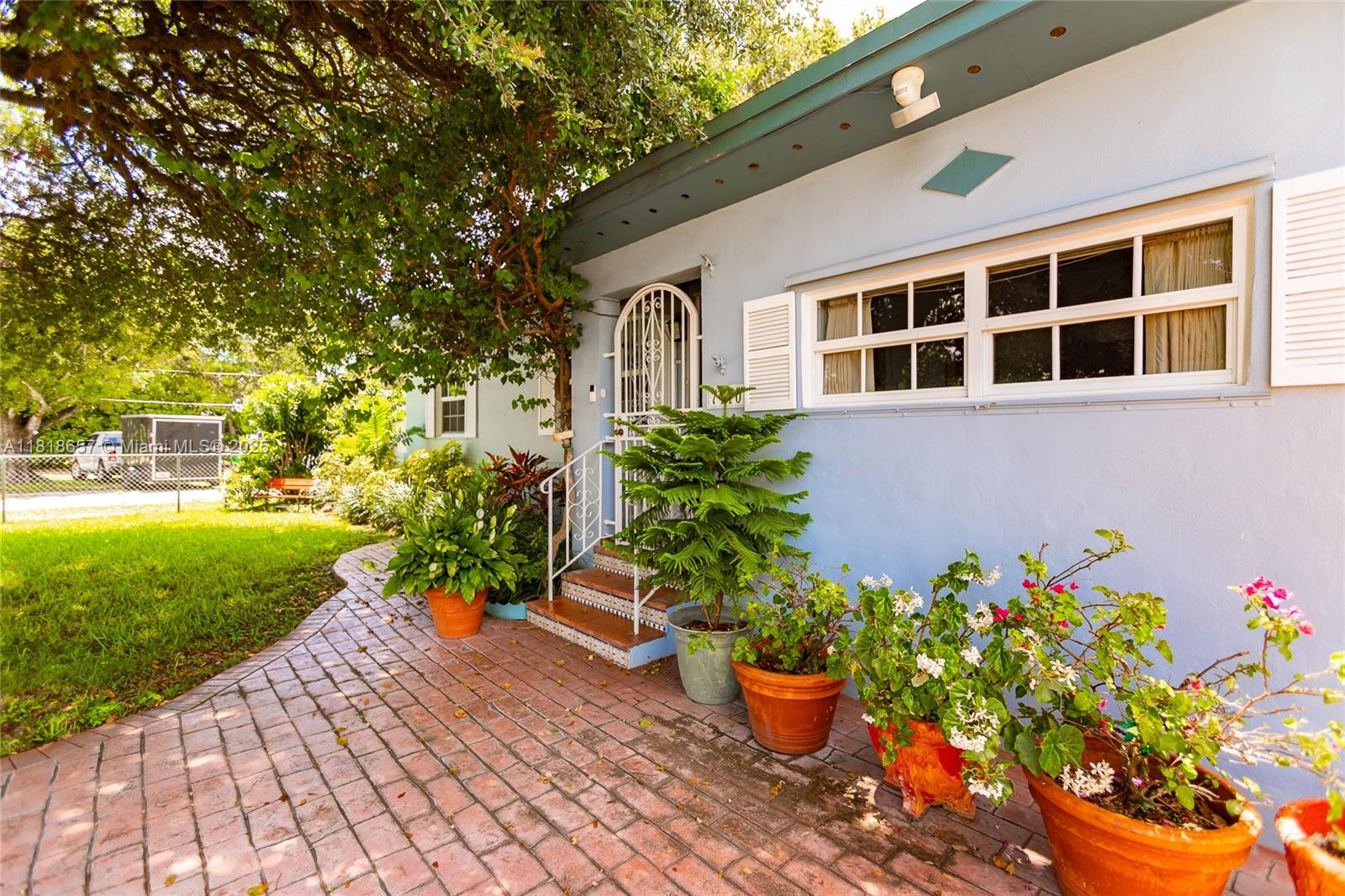 7110 Southwest 13th Terrace Miami, FL 33144 - Photo 4 of 48 a front view of a house with a yard