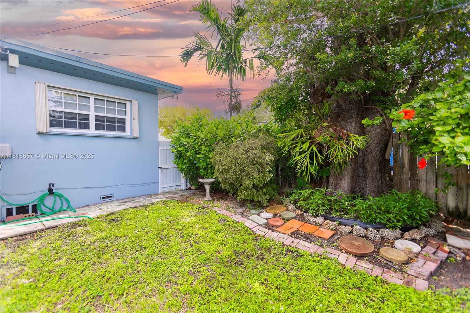 7110 Southwest 13th Terrace Miami, FL 33144 - Photo 46 of 48 a backyard of a house with table and chairs
