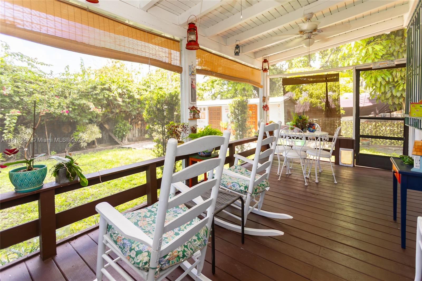 7110 Southwest 13th Terrace Miami, FL 33144 - Photo 48 of 48 a living room with large windows and wooden floor