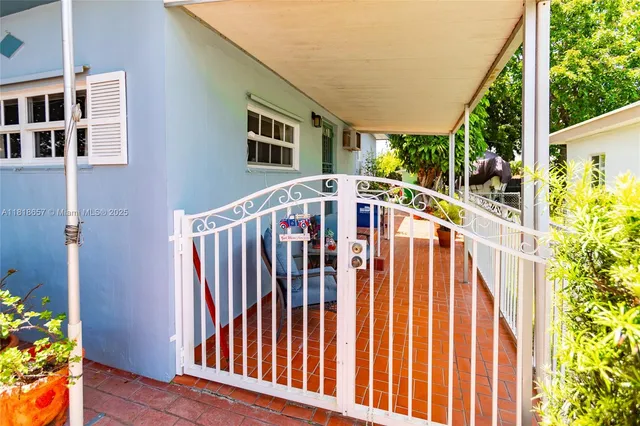 a view of a house with balcony and wooden floor
