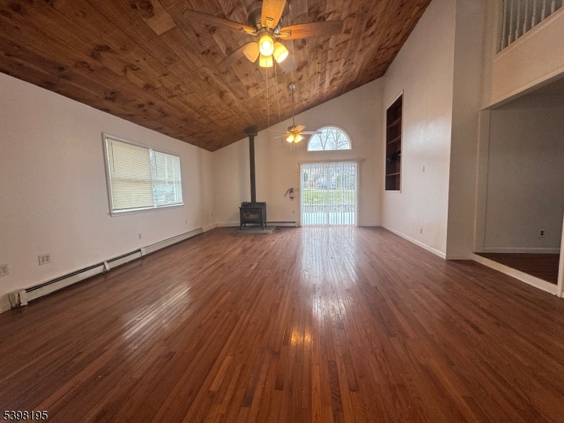 252 Wiscasset Road Vernon, NJ 07422 - Photo 3 of 10 an empty room with wooden floor and windows