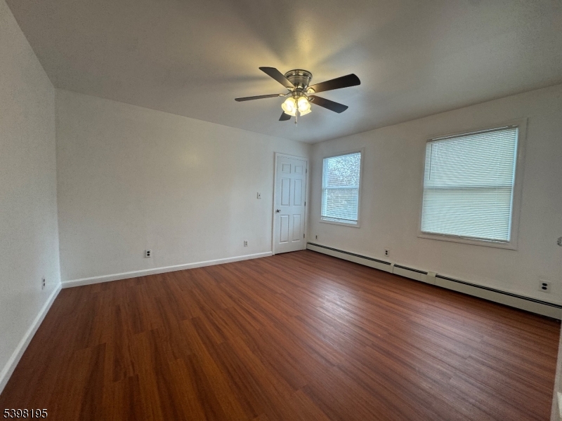 252 Wiscasset Road Vernon, NJ 07422 - Photo 6 of 10 wooden floor in an empty room with a window