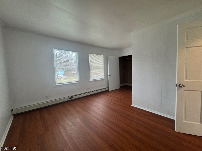 252 Wiscasset Road Vernon, NJ 07422 - Photo 8 of 10 an empty room with wooden floor and windows