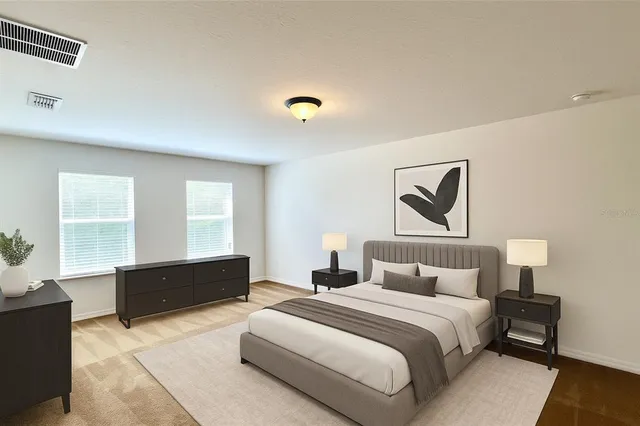 a bedroom with a bed and a painting on the wall