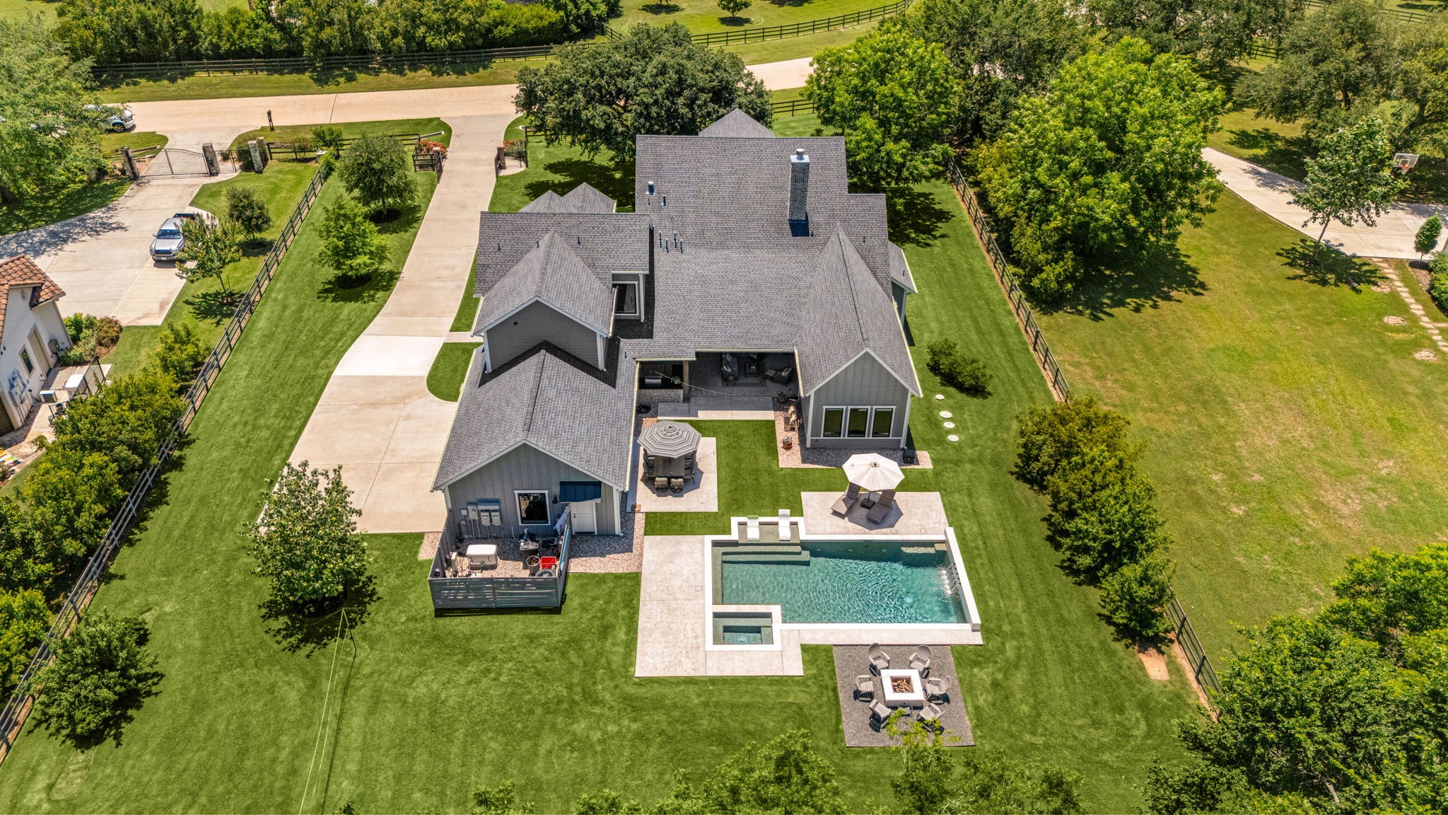 4311 Upper Oxbow Trace Fulshear, TX 77441 - Photo 46 of 49 Expansive backyard showcasing the pool, outdoor entertaining spaces, and oversized lot.