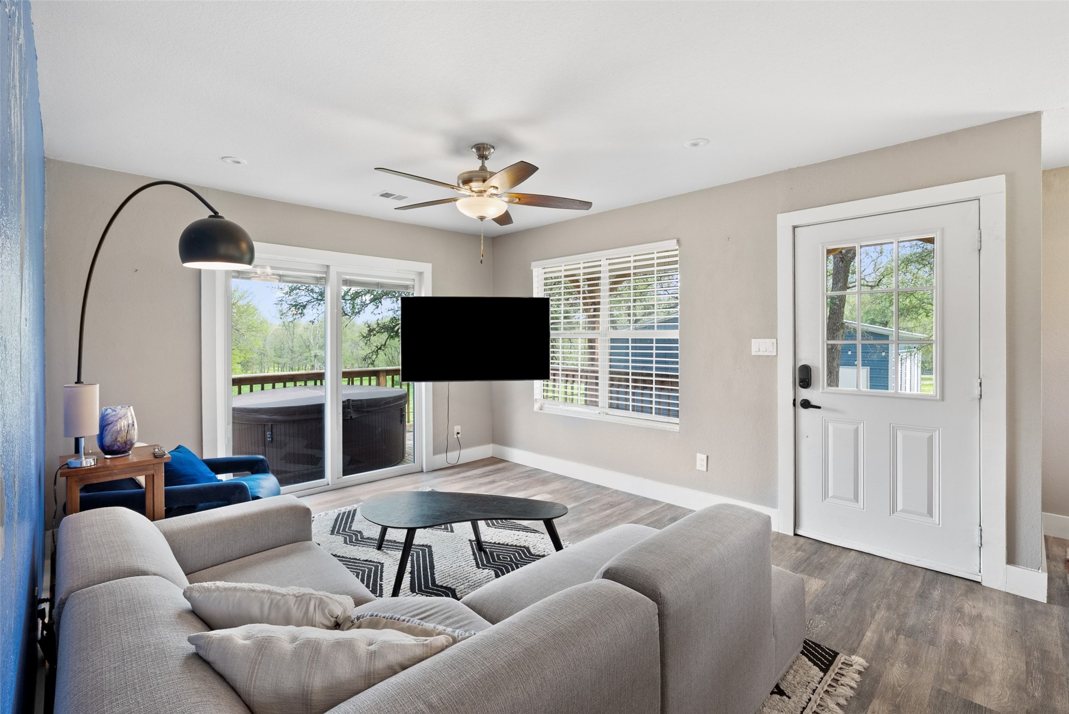 274 Old Austin Trail Elgin, TX 78621 - Photo 11 of 32 a living room with furniture a flat screen tv and a large window