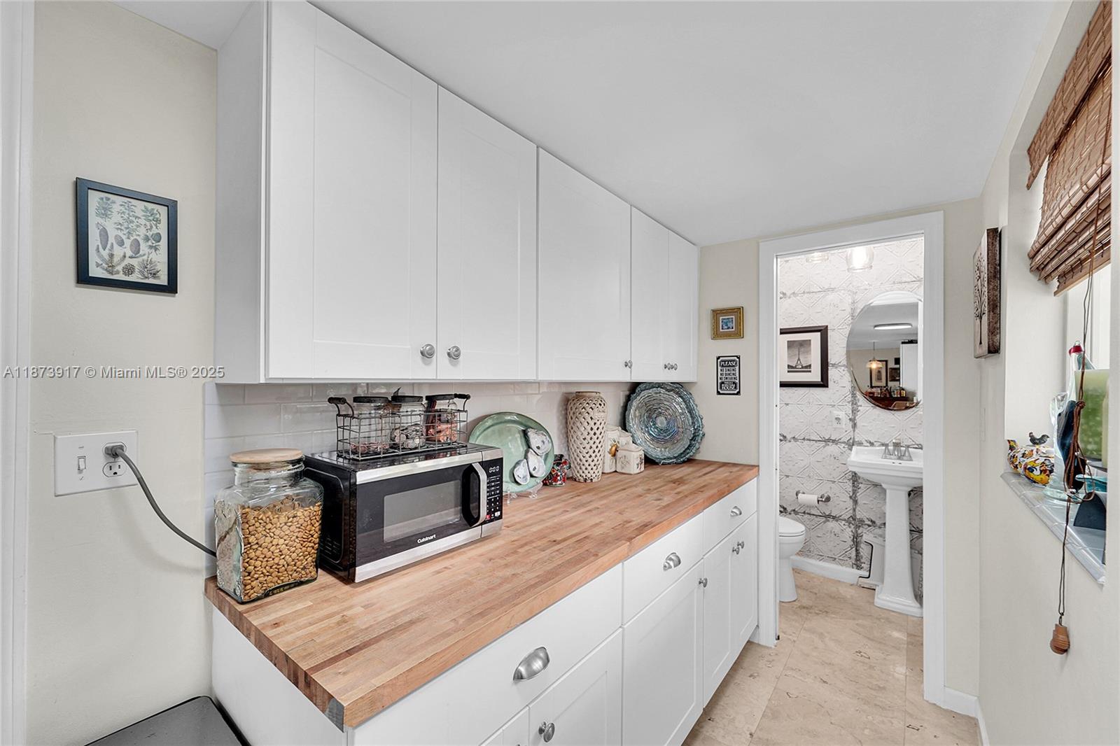 1431 South Ocean Boulevard, Unit 11 Lauderdale-by-the-Sea, FL 33062 - Photo 12 of 42 a kitchen with stainless steel appliances granite countertop a sink stove and cabinets