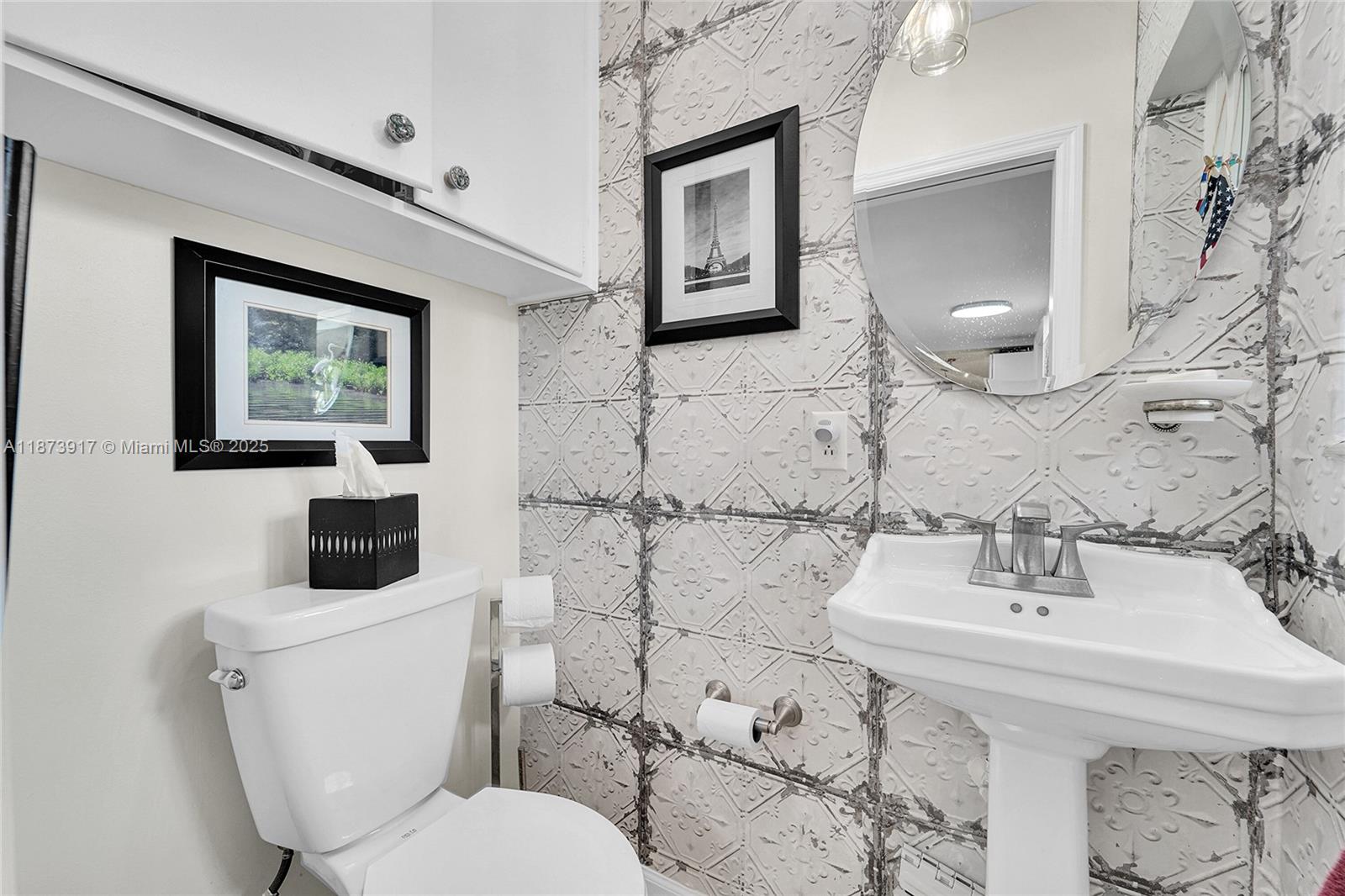 1431 South Ocean Boulevard, Unit 11 Lauderdale-by-the-Sea, FL 33062 - Photo 13 of 42 a bathroom with a toilet sink and mirror