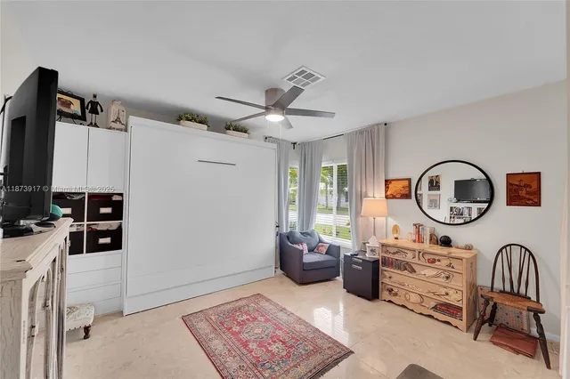a living room with furniture a air conditioner vent and a window