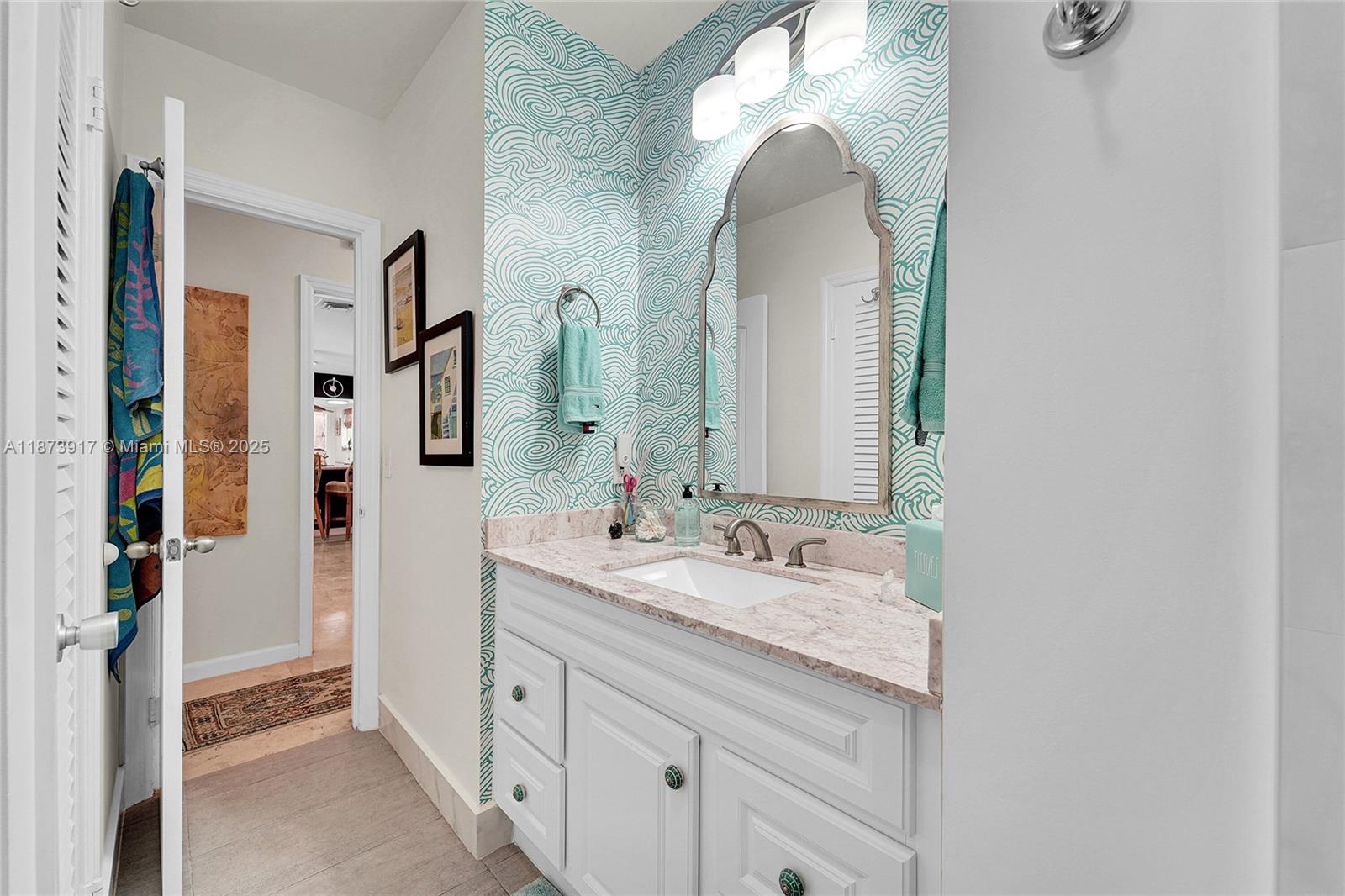 1431 South Ocean Boulevard, Unit 11 Lauderdale-by-the-Sea, FL 33062 - Photo 18 of 42 a spacious bathroom with a double vanity sink and a mirror