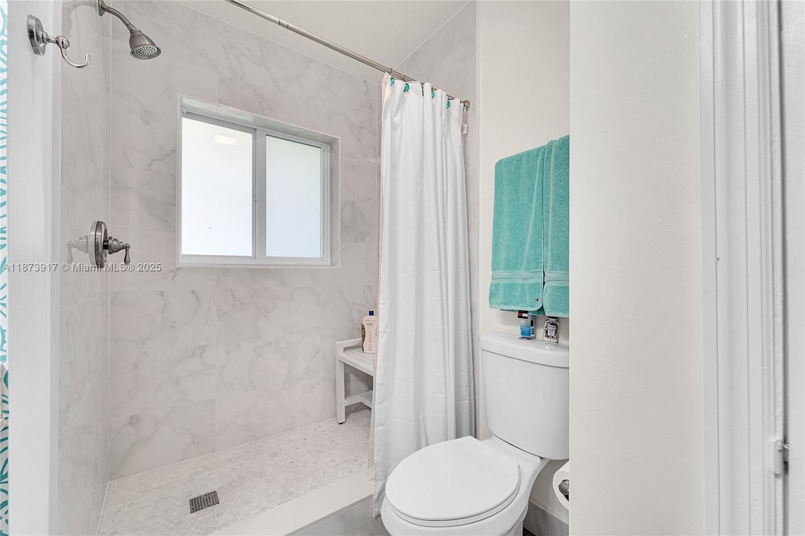 1431 South Ocean Boulevard, Unit 11 Lauderdale-by-the-Sea, FL 33062 - Photo 20 of 42 a white toilet sitting next to a bathroom sink