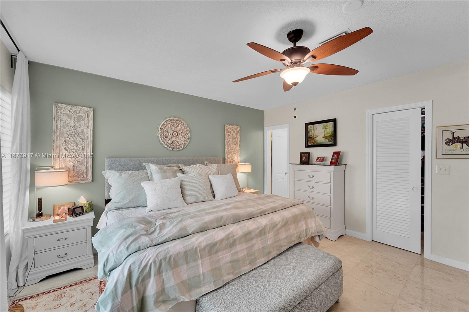 1431 South Ocean Boulevard, Unit 11 Lauderdale-by-the-Sea, FL 33062 - Photo 23 of 42 a bedroom with a large bed and a chandelier