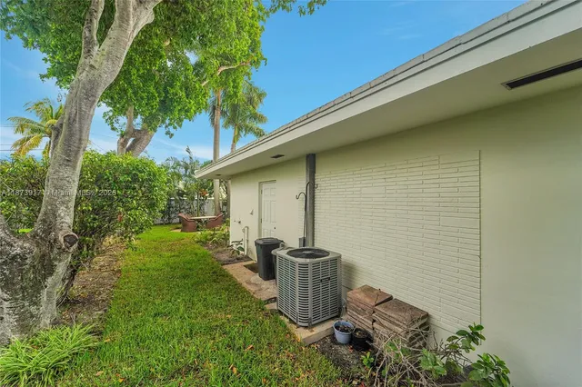 a backyard of a house with table and chairs